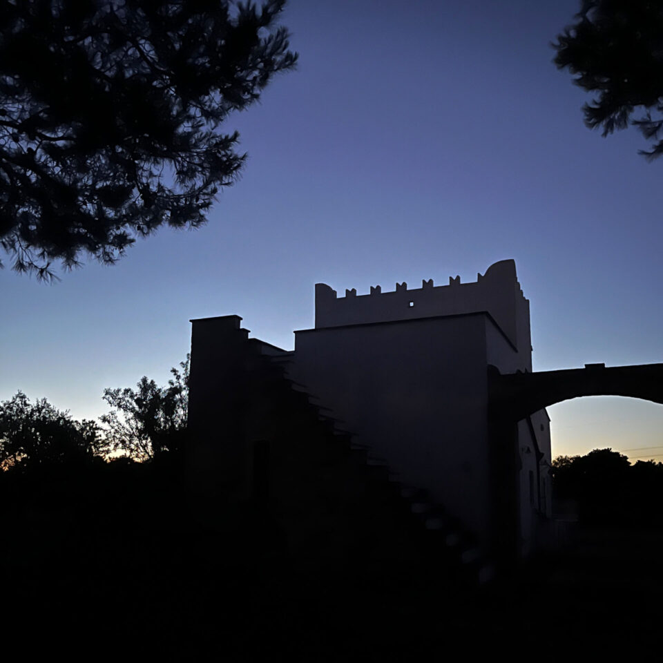 The silhouette of the masseria after sunset