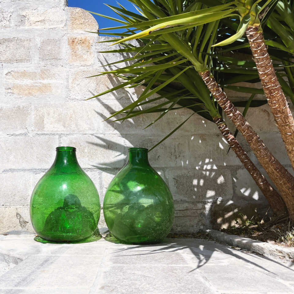 Two traditional wine galleons under a yucca palm in the courtyard