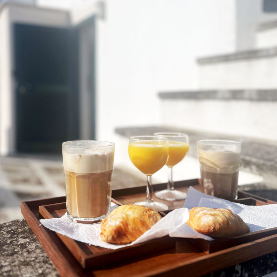 An italien breakfast in the morning sun on the rooftop